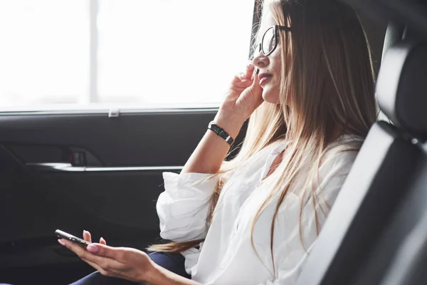 Touches Glasses Beautiful Blonde Girl Sitting New Car Modern Black — стоковое фото