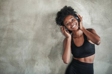 Samimi bir gülümseme. Spor yaptıktan sonra spor kıyafetli Afrikalı Amerikalı bir kızın portresi..