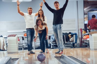 İyi atıştı. Genç neşeli arkadaşlar hafta sonları bowling kulübünde eğleniyorlar..