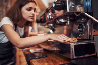 Kız temizlik makinesi. Genç bayan kafe çalışanı içeride. İş ve hizmet kavramı.