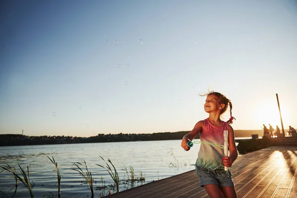 Evening Time Happy Little Girl Playing Bubbles Lake Park — Stock Photo, Image