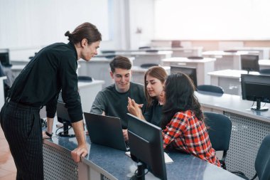 Gevşeme. Modern ofiste çalışan günlük kıyafetli bir grup genç..