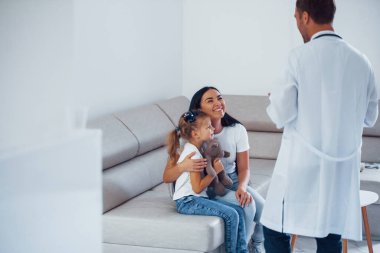 Anne ve tatlı kızı kliniği ziyaret ediyor. Doktoru dinliyorum..