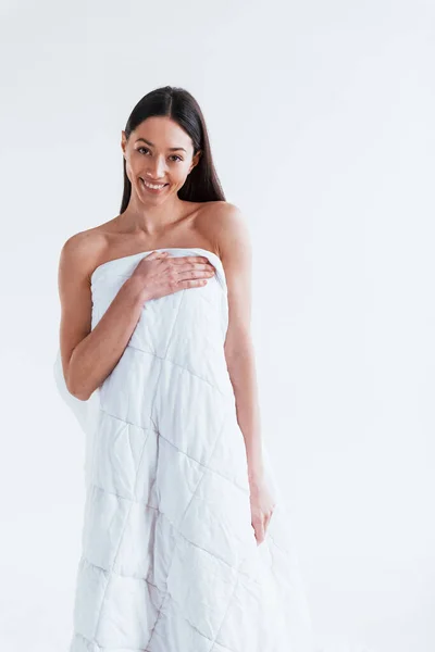 若いです女性カバー彼女の体にタオルでスタジオで白の背景 — ストック写真