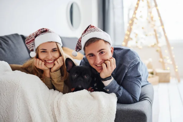 Счастливая Молодая Пара Рождественских Шляпах Лежащая Дома Диване Своей Милой — стоковое фото