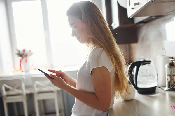 Side View Blonde Long Hair White Shirt Stands Kitchen Using — Stock Photo, Image