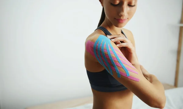 Sportive Woman Sits Indoors Kinesio Tape Her Shoulder — Stock Photo, Image