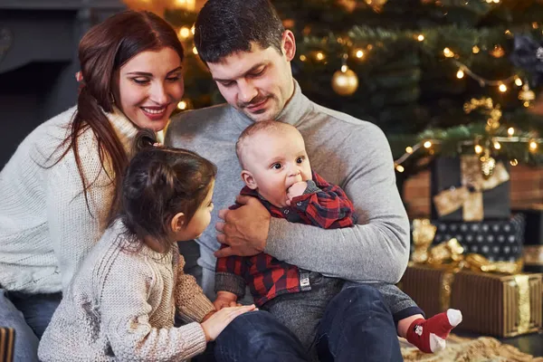 美丽的高加索夫妇带着他们的小儿子和女儿在屋里庆祝圣诞节 — 图库照片