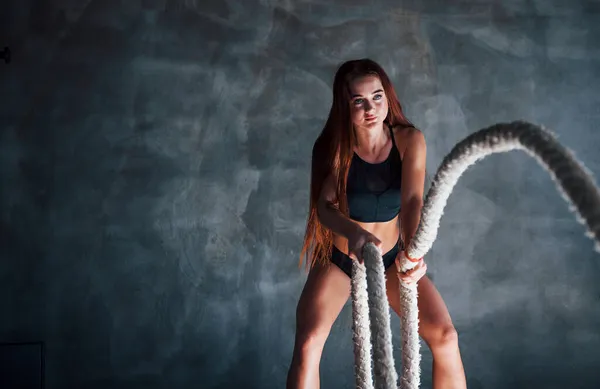 Zayıf Vücutlu Genç Bir Fitness Kadını Ellerinde Düğümlerle Egzersiz Yapıyor — Stok fotoğraf