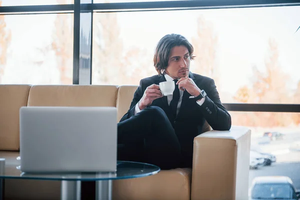 Portrait Handsome Young Businessman Black Suit Tie Sits Sofa Takes — Stock Photo, Image