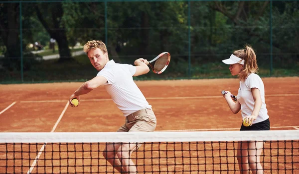 スポーツユニフォームを着た2人がコートでテニスをする — ストック写真