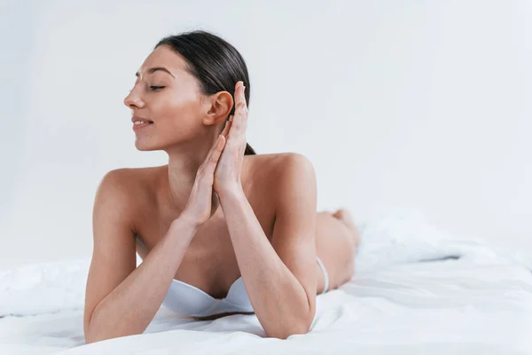 Mulher Sorrindo Positivo Roupa Interior Deitado Estúdio Contra Fundo Branco — Fotografia de Stock