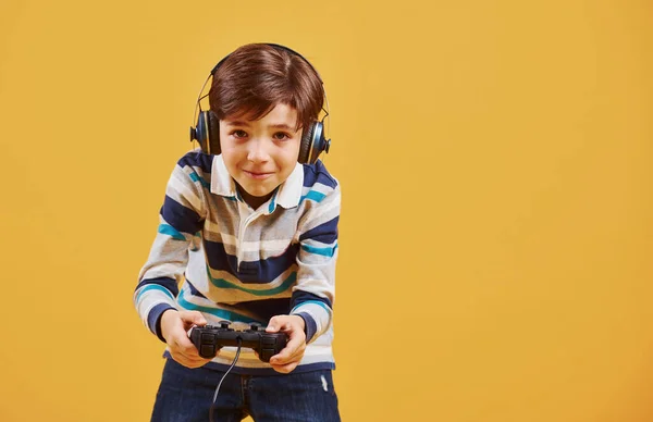 Netter Kleiner Junge Spielt Videospiel Studio Vor Gelbem Hintergrund — Stockfoto
