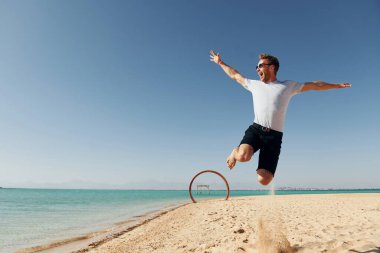 Having fun. Young european man have vacation and enjoying free time on the beach of sea.