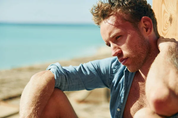 Genç Avrupalı adam tatilde ve deniz kıyısında boş zamanlarının tadını çıkarıyor..