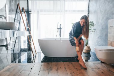 Beautiful young woman have free time at home in the bath.