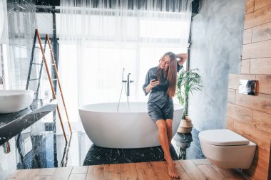 Beautiful young woman have free time at home in the bath.