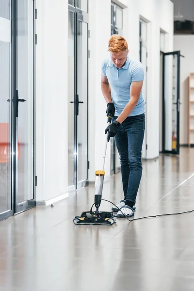 Young Man Works Modern Office Uses Vacuum Cleaner — Stok fotoğraf