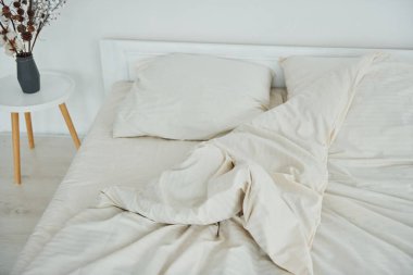 White bed. Interior and design of beautiful modern bedroom at daytime.