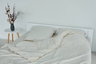 White bed. Interior and design of beautiful modern bedroom at daytime.