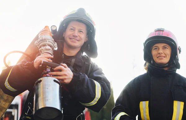 Male Female Firefighters Protective Uniform Outdoors Together — Zdjęcie stockowe