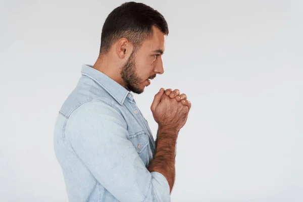 Guy Praying Young Handsome Man Standing Indoors White Background — Stockfoto