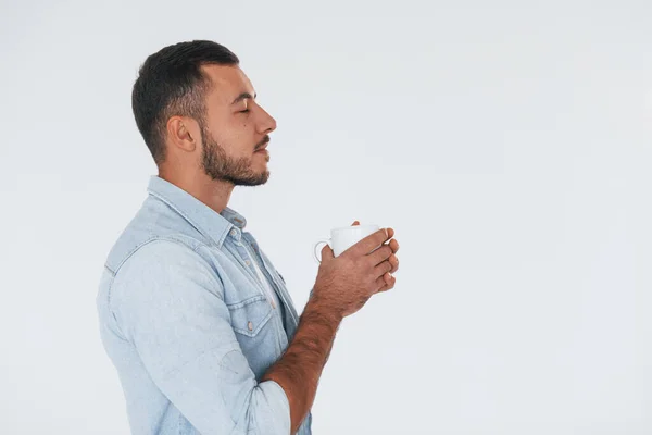 Holds White Cup Young Handsome Man Standing Indoors White Background Stockbild