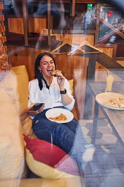 Young Brunette Sitting Indoors Pizza Smartphone Hand — Foto de Stock