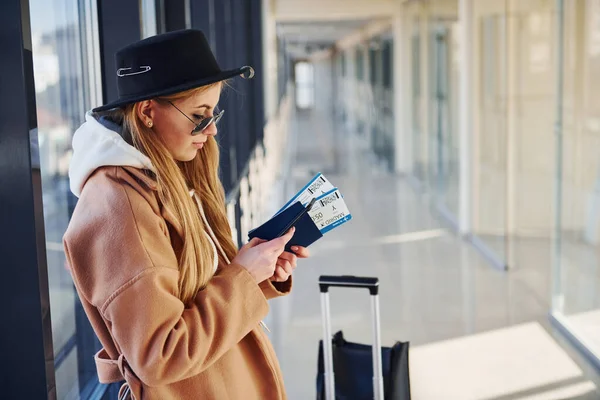 Young Woman Sunglasses Warm Clothes Hat Standing Indoors Airport Phone — стоковое фото