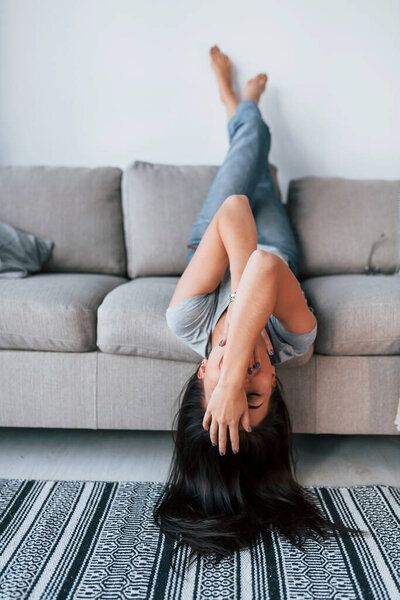 Young beautiful woman in casual clothes lying down on the bed and have fun at home alone.