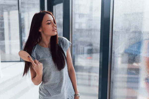 Beautiful Young Brunette Grey Shirt Standing Window Posing Camera — стоковое фото