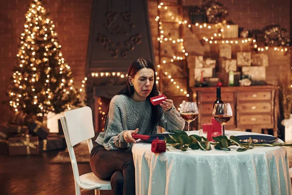 Young Disappointed Brunette Sits Table Restaurant Holds Red Box Gift — ストック写真