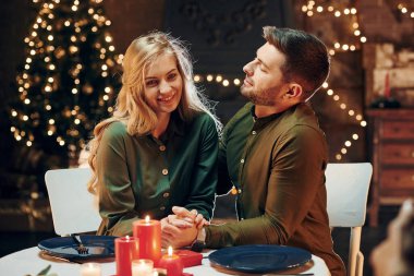 İlişki kavramı. Genç ve güzel çift evde romantik bir akşam yemeği yiyor..