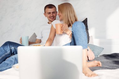 Young lovely couple together at home spending weekend and holidays together.