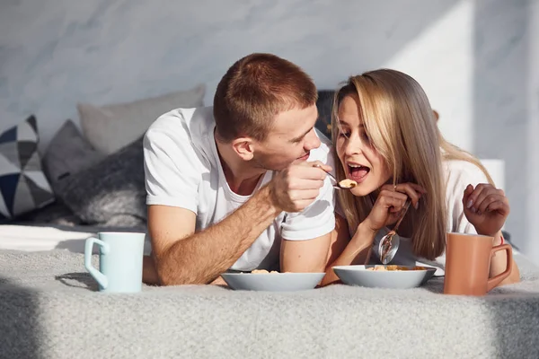 Young Lovely Couple Have Breakfast Home While Lying Bed —  Fotos de Stock