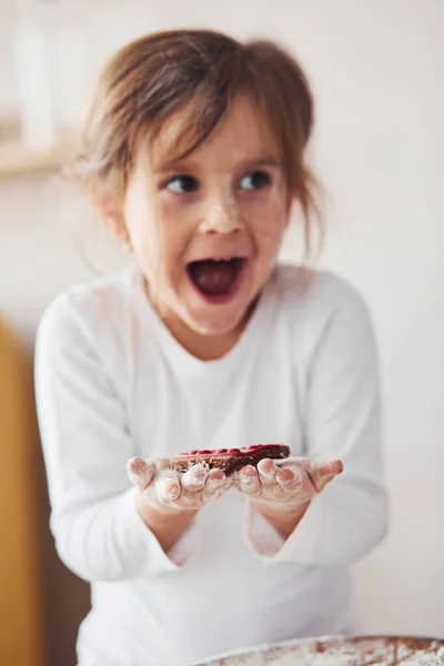 Positive Little Girl Holding Sweet Cookie Hands Kitchen — Stock Photo, Image
