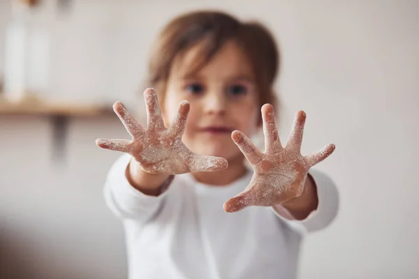 Positive Little Girl Showing Hands Flour Kitchen — Zdjęcie stockowe