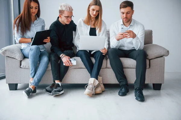 Group Friends Sitting Sofa Laptop Phones Together — Foto Stock