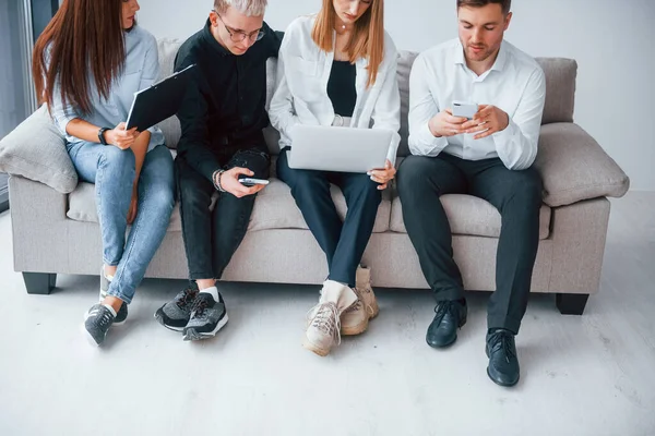 Group Friends Sitting Sofa Laptop Phones Together — Foto Stock