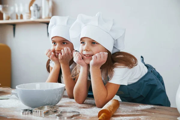 Two Little Girls Blue Chef Uniform Smiling Together Kitchen — Zdjęcie stockowe