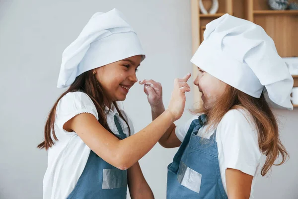 Two Little Girls Blue Chef Uniform Have Fun Flour Kitchen — Zdjęcie stockowe