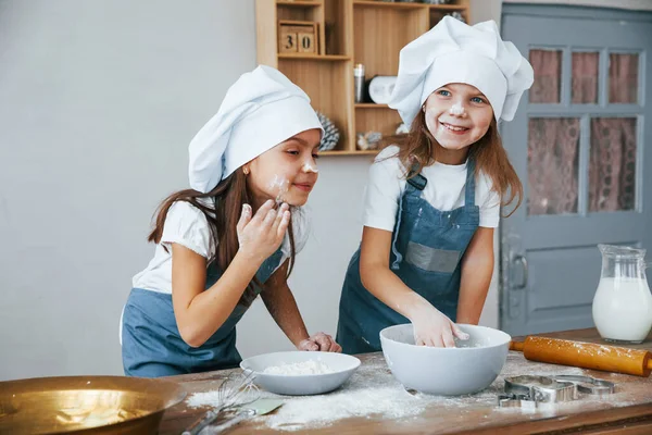 Two Little Girls Blue Chef Uniform Have Fun Flour Kitchen — стоковое фото