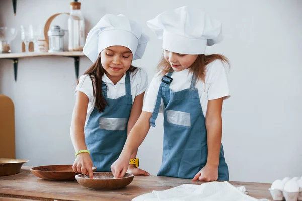 Two Little Girls Blue Chef Uniform Working Flour Kitchen — стоковое фото