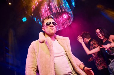 Gençler gece kulübünde renkli lazer ışıklarıyla eğleniyorlar..