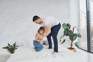 Happy father with his daughter have fun at home together.