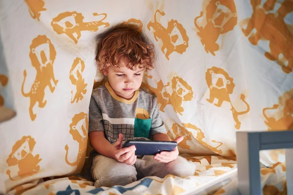 Cute Little Boy Resting Have Fun Indoors Blanket Phone Hands — стоковое фото