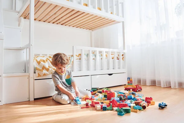 Cute Little Boy Sitting Have Fun Indoors Bedroom Plastic Construction —  Fotos de Stock