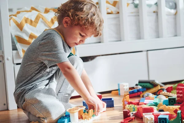 Cute Little Boy Sitting Have Fun Indoors Bedroom Plastic Construction —  Fotos de Stock