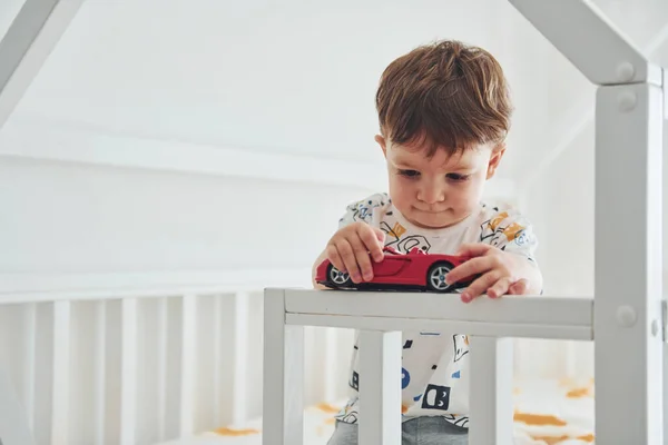 Cute Little Boy Resting Have Fun Car Indoors Bedroom — Stockfoto