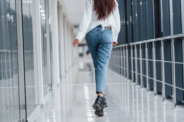 Rear View Brunette White Shirt Walks Indoors Modern Airport Hallway — Fotografia de Stock